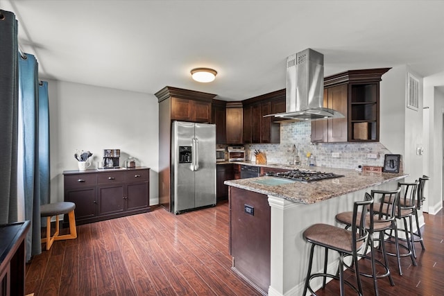 427 Cedarcrest Dr, Streamwood, IL 60107 - kitchen with appliances with stainless steel finishes, island exhaust hood, dark wood finished floors, a peninsula, and open shelves