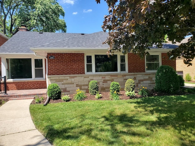 1308 Frances Pkwy, Park Ridge, IL 60068 - view of front facade with stone siding, roof with shingles, a front yard, and a chimney