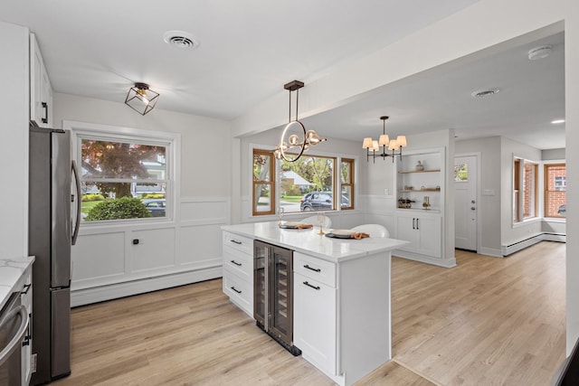 1308 Frances Pkwy, Park Ridge, IL 60068 - kitchen with freestanding refrigerator, beverage cooler, a chandelier, white cabinets, and light stone counters