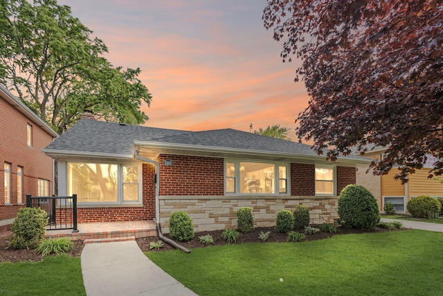 1308 Frances Pkwy, Park Ridge, IL 60068 - view of front of house with a shingled roof, a yard, brick siding, stone siding, and a chimney
