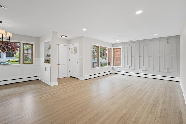 1308 Frances Pkwy, Park Ridge, IL 60068 - unfurnished living room with wood finished floors, a baseboard radiator, recessed lighting, a chandelier, and baseboards