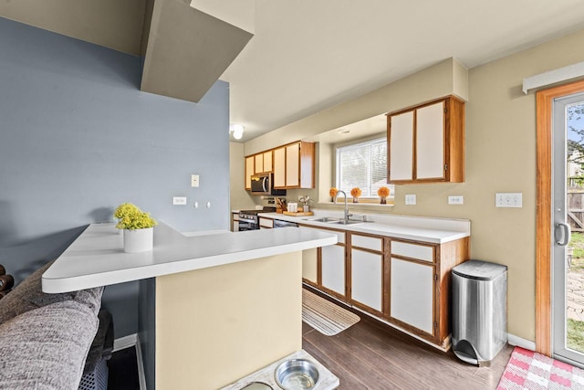 1861 Grosse Pointe Cir, Hanover Park, IL 60133 - kitchen with stainless steel appliances, wood finished floors, light countertops, and a breakfast bar