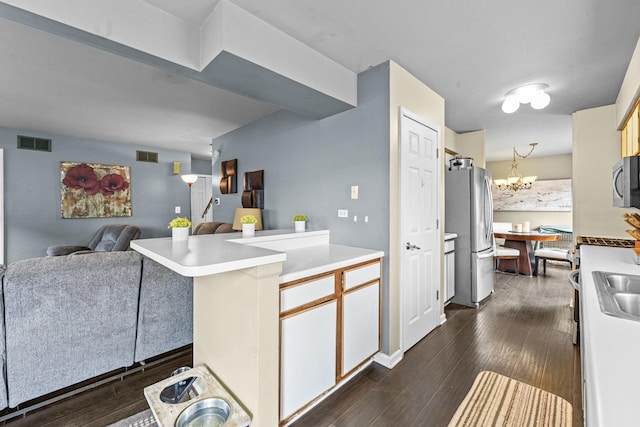1861 Grosse Pointe Cir, Hanover Park, IL 60133 - kitchen with a peninsula, a chandelier, open floor plan, appliances with stainless steel finishes, and light countertops