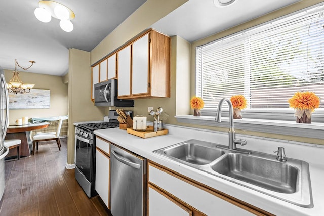 1861 Grosse Pointe Cir, Hanover Park, IL 60133 - kitchen featuring appliances with stainless steel finishes, light countertops, dark wood-style flooring, a chandelier, and pendant lighting