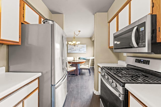 1861 Grosse Pointe Cir, Hanover Park, IL 60133 - kitchen featuring stainless steel appliances, light countertops, a chandelier, and dark wood-type flooring