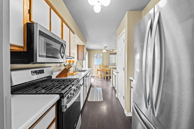 1861 Grosse Pointe Cir, Hanover Park, IL 60133 - kitchen with stainless steel appliances, dark wood-style flooring, light countertops, and a ceiling fan