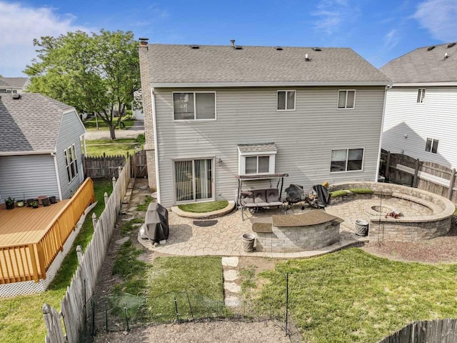1861 Grosse Pointe Cir, Hanover Park, IL 60133 - back of property with an outdoor fire pit, a chimney, a patio, a fenced backyard, and a shingled roof