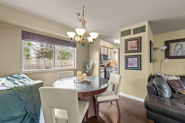 1861 Grosse Pointe Cir, Hanover Park, IL 60133 - dining area with a chandelier and dark wood-style floors