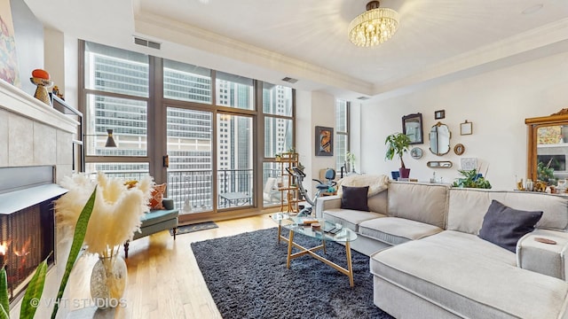 212 W Washington St Unit 1108, Chicago, IL 60606 - living room featuring wood finished floors, ornamental molding, a raised ceiling, and a chandelier