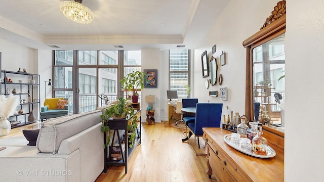 212 W Washington St Unit 1108, Chicago, IL 60606 - living area featuring plenty of natural light, light wood-style floors, a chandelier, and a desk