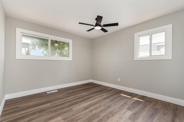 16632 Sawyer Ave, Markham, IL 60428 - empty room featuring plenty of natural light, dark wood-style floors, and a ceiling fan