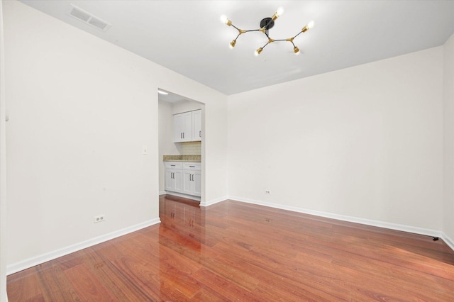 881 Dandridge Ct, Elgin, IL 60120 - unfurnished room with a chandelier and wood finished floors