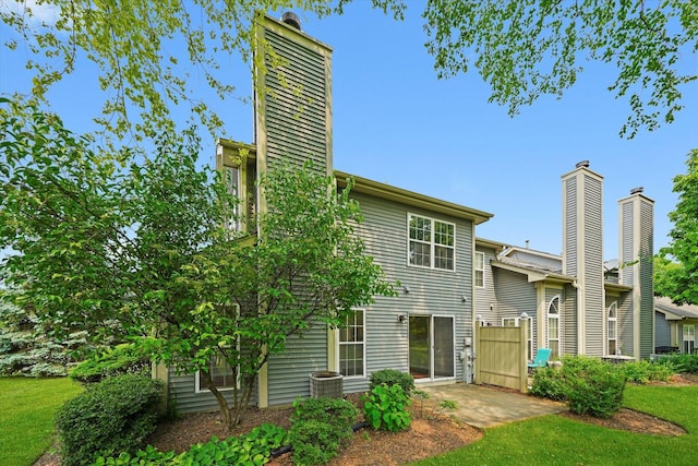 881 Dandridge Ct, Elgin, IL 60120 - rear view of property featuring a patio, a chimney, and a yard
