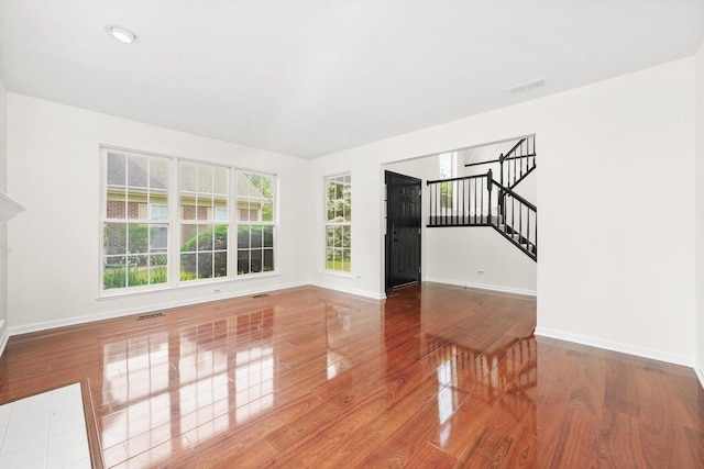 881 Dandridge Ct, Elgin, IL 60120 - unfurnished living room featuring wood finished floors, healthy amount of natural light, and stairs