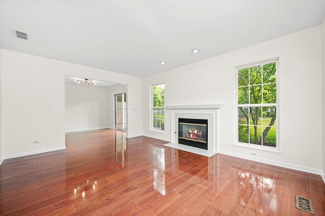 881 Dandridge Ct, Elgin, IL 60120 - unfurnished living room featuring wood finished floors, a fireplace with flush hearth, and recessed lighting