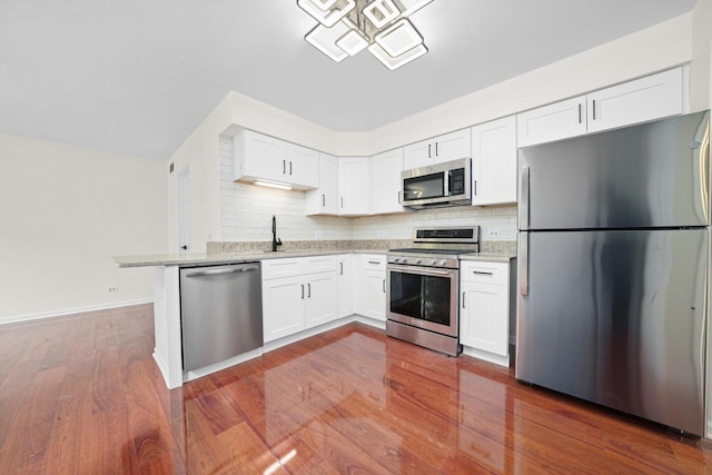881 Dandridge Ct, Elgin, IL 60120 - kitchen featuring appliances with stainless steel finishes, tasteful backsplash, white cabinets, and dark wood-type flooring