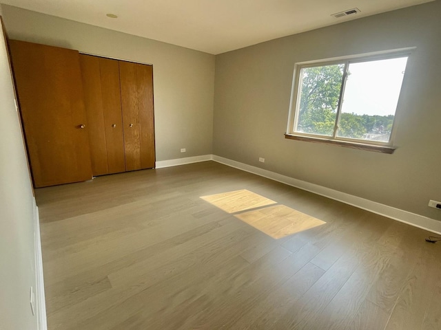 4125 N Keystone Ave Unit 605, Chicago, IL 60641 - unfurnished bedroom featuring wood finished floors and a closet