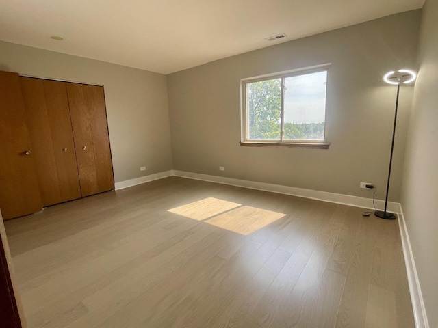 4125 N Keystone Ave Unit 605, Chicago, IL 60641 - unfurnished bedroom featuring wood finished floors and a closet
