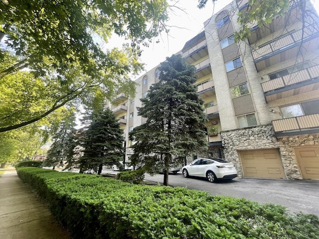 4125 N Keystone Ave Unit 605, Chicago, IL 60641 - view of apartment building / complex featuring driveway and an attached garage
