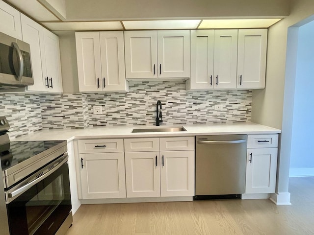 4125 N Keystone Ave Unit 605, Chicago, IL 60641 - kitchen featuring appliances with stainless steel finishes, light wood finished floors, light countertops, and backsplash
