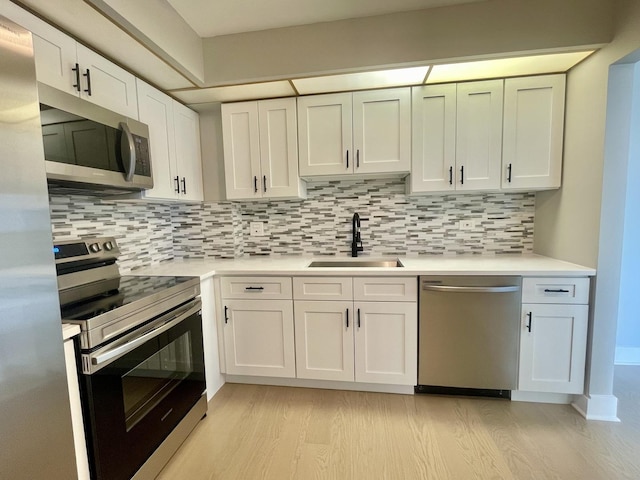 4125 N Keystone Ave Unit 605, Chicago, IL 60641 - kitchen with appliances with stainless steel finishes, light wood-type flooring, light countertops, and decorative backsplash