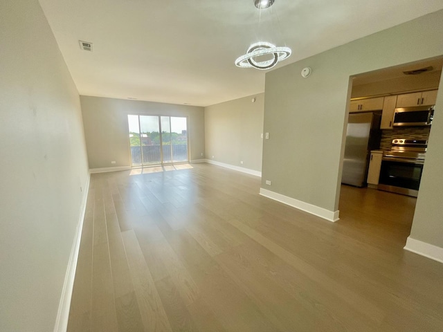 4125 N Keystone Ave Unit 605, Chicago, IL 60641 - unfurnished living room with light wood-style floors and a chandelier
