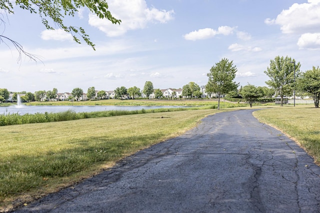 1913 Cobblestone Dr Unit 1913, Carpentersville, IL 60110 - view of asphalt road featuring a water view