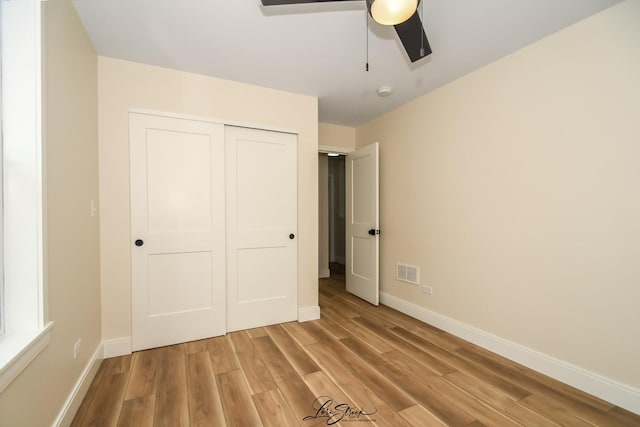 223 E 20th Ct, Lockport, IL 60441 - unfurnished bedroom featuring light wood-style floors, a closet, and a ceiling fan