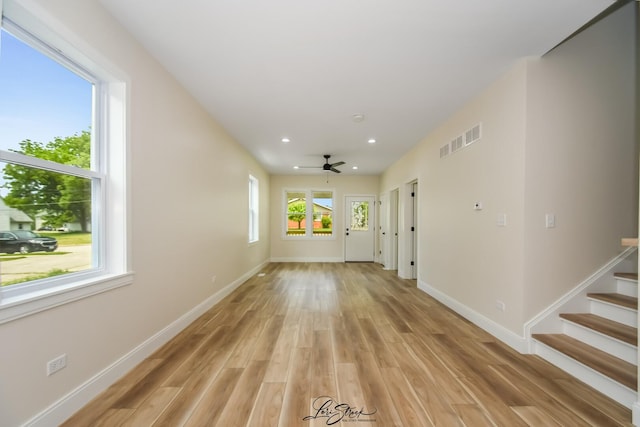 223 E 20th Ct, Lockport, IL 60441 - unfurnished living room with light wood finished floors, ceiling fan, recessed lighting, and stairway