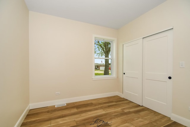 223 E 20th Ct, Lockport, IL 60441 - unfurnished bedroom featuring light wood finished floors and a closet