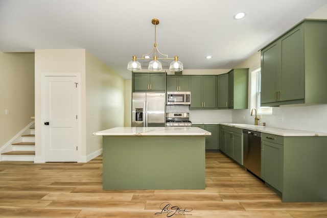 223 E 20th Ct, Lockport, IL 60441 - kitchen with green cabinetry, appliances with stainless steel finishes, light countertops, light wood-type flooring, and tasteful backsplash
