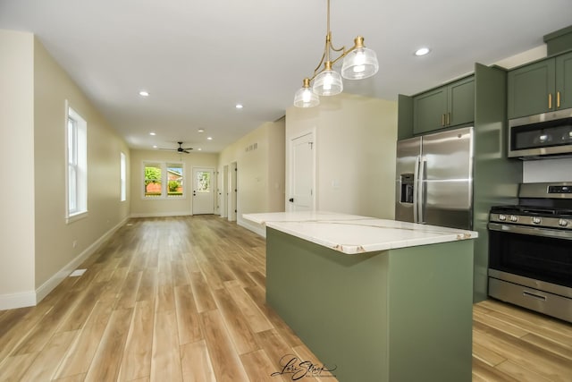 223 E 20th Ct, Lockport, IL 60441 - kitchen with appliances with stainless steel finishes, green cabinets, light wood-style flooring, a center island, and light stone counters