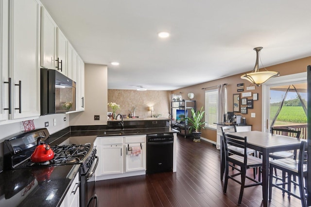 2025 Westbury Ln, Aurora, IL 60502 - kitchen featuring black appliances, dark countertops, a peninsula, white cabinets, and dark wood-type flooring