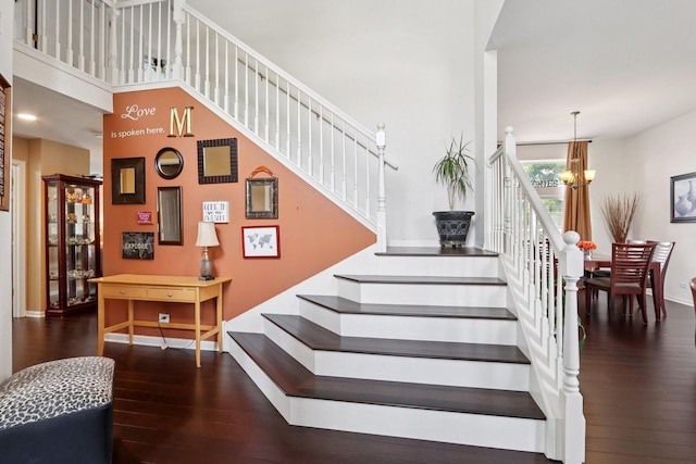 2025 Westbury Ln, Aurora, IL 60502 - staircase with a chandelier, hardwood / wood-style flooring, and a towering ceiling