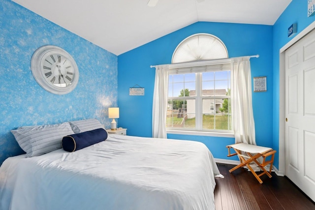 2025 Westbury Ln, Aurora, IL 60502 - bedroom featuring an accent wall, wallpapered walls, hardwood / wood-style flooring, vaulted ceiling, and ceiling fan