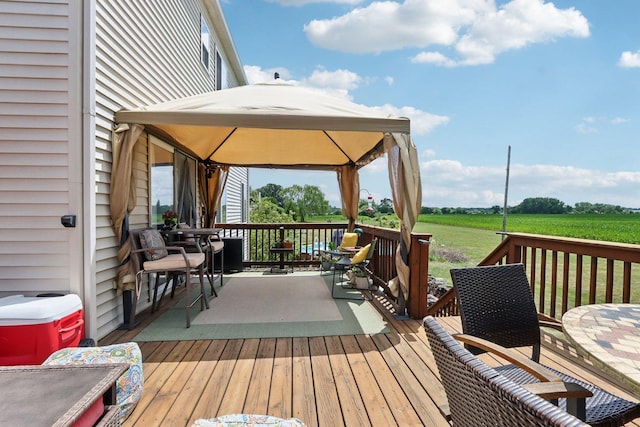 2025 Westbury Ln, Aurora, IL 60502 - wooden terrace featuring a gazebo, outdoor dining space, and a rural view