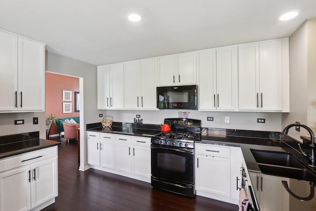 2025 Westbury Ln, Aurora, IL 60502 - kitchen with black appliances, dark wood finished floors, white cabinetry, dark countertops, and recessed lighting