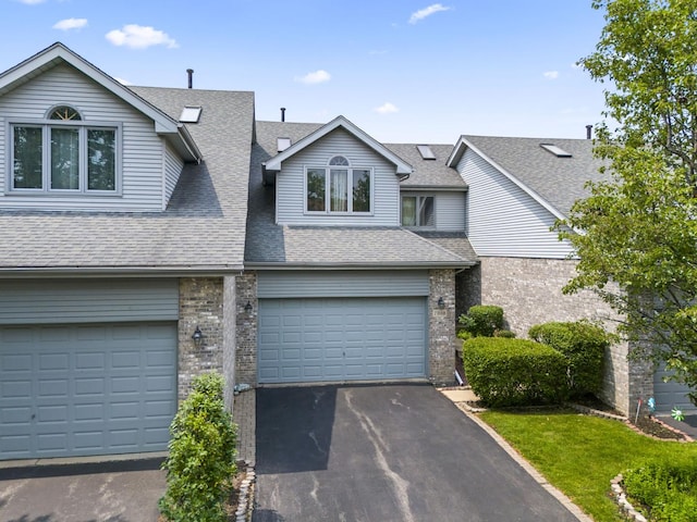 7008 Plymouth Ct Unit 7008, Tinley Park, IL 60477 - view of front facade featuring roof with shingles, driveway, a garage, and brick siding