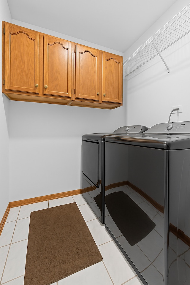 7008 Plymouth Ct Unit 7008, Tinley Park, IL 60477 - laundry room featuring washer and dryer, cabinet space, and light tile patterned flooring