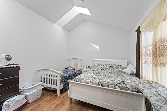 7008 Plymouth Ct Unit 7008, Tinley Park, IL 60477 - bedroom featuring lofted ceiling, a skylight, and wood finished floors