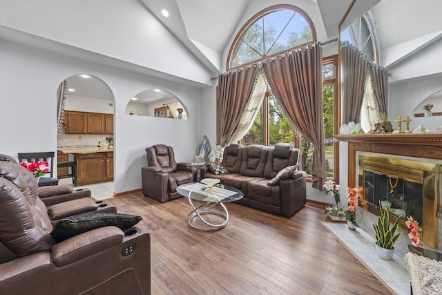 7008 Plymouth Ct Unit 7008, Tinley Park, IL 60477 - living area with a fireplace with flush hearth, high vaulted ceiling, light wood-type flooring, and recessed lighting