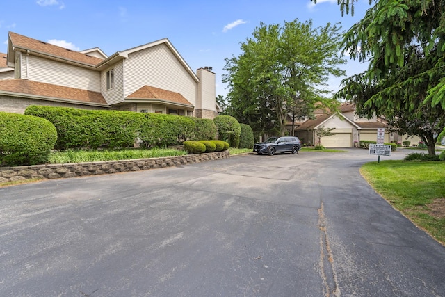 7008 Plymouth Ct Unit 7008, Tinley Park, IL 60477 - view of property exterior featuring a chimney