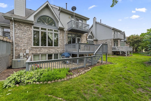 7008 Plymouth Ct Unit 7008, Tinley Park, IL 60477 - back of property featuring a balcony, a yard, brick siding, and a deck
