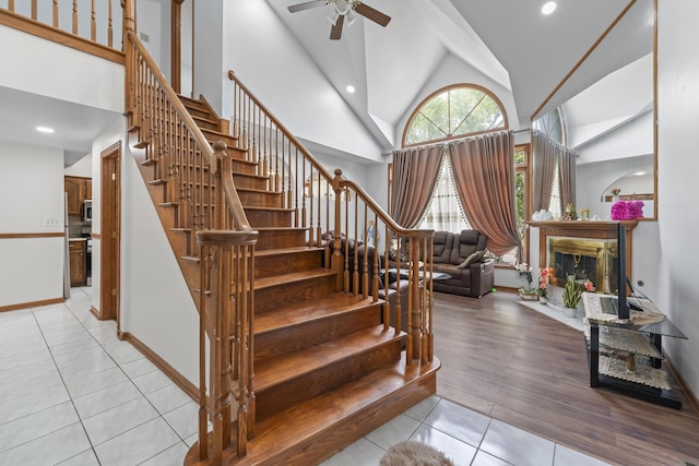 7008 Plymouth Ct Unit 7008, Tinley Park, IL 60477 - stairs featuring tile patterned floors, a ceiling fan, high vaulted ceiling, a fireplace, and recessed lighting