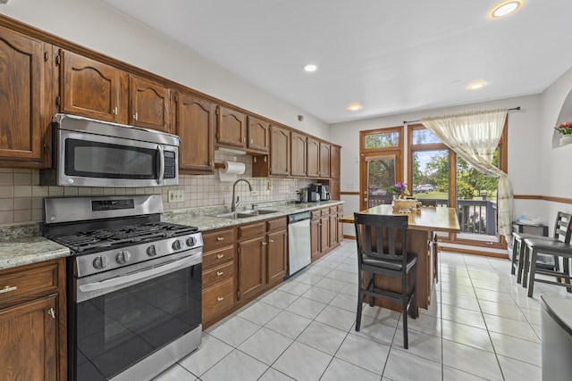 7008 Plymouth Ct Unit 7008, Tinley Park, IL 60477 - kitchen featuring stainless steel appliances, backsplash, light stone countertops, light tile patterned floors, and recessed lighting