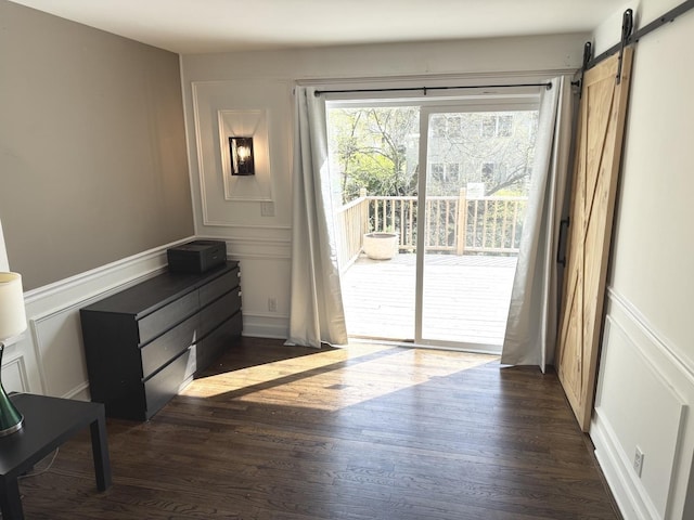 21317 W Shady Ln, Lake Zurich, IL 60047 - entryway featuring a decorative wall, dark wood finished floors, a barn door, and wainscoting