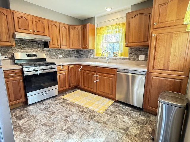 21317 W Shady Ln, Lake Zurich, IL 60047 - kitchen with stainless steel appliances, under cabinet range hood, a sink, decorative backsplash, and light countertops