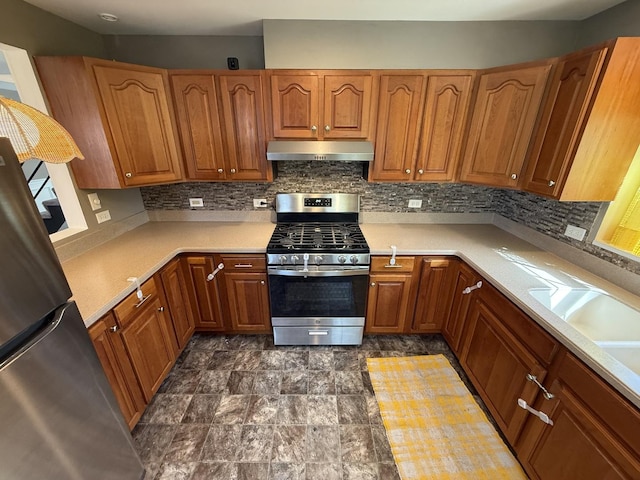 21317 W Shady Ln, Lake Zurich, IL 60047 - kitchen featuring stainless steel appliances, under cabinet range hood, decorative backsplash, light countertops, and brown cabinetry