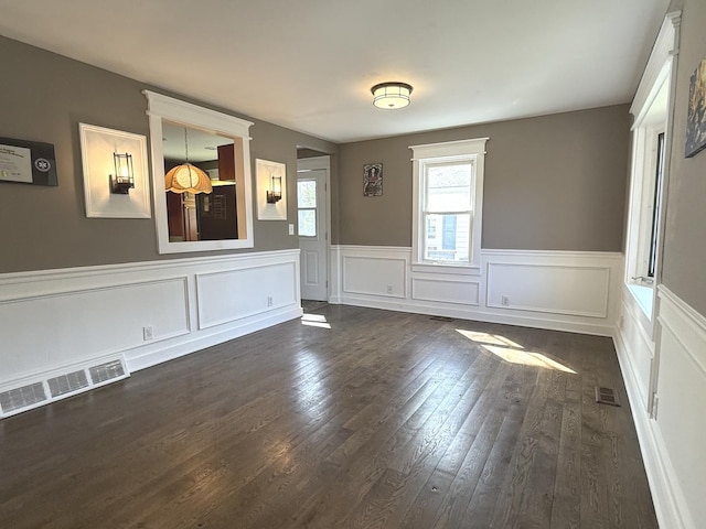 21317 W Shady Ln, Lake Zurich, IL 60047 - empty room featuring dark wood-style floors, a wainscoted wall, and a decorative wall