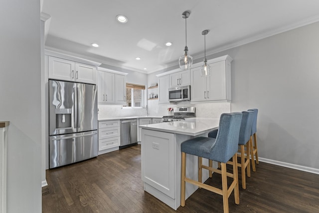6351 N Glenwood Ave Unit 1S, Chicago, IL 60660 - kitchen featuring appliances with stainless steel finishes, a peninsula, ornamental molding, recessed lighting, and light countertops